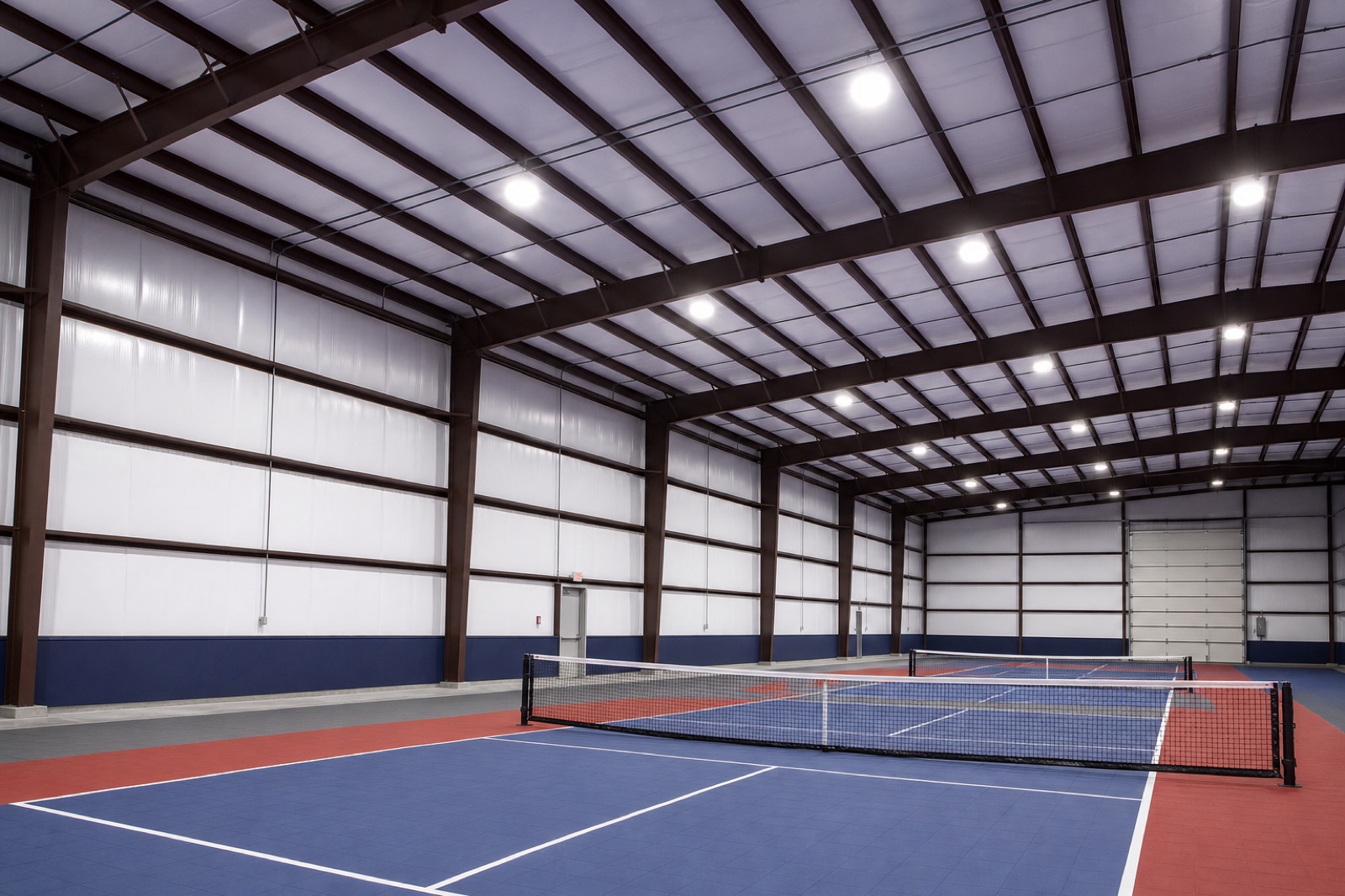 Finished indoor pickleball facility with multiple courts and divider systems