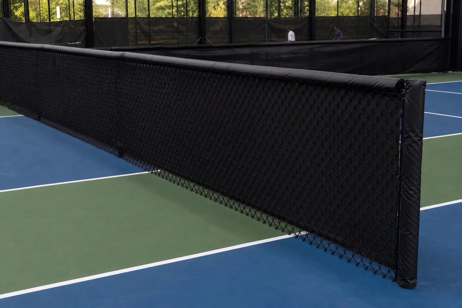 Low divider fencing between completed pickleball courts