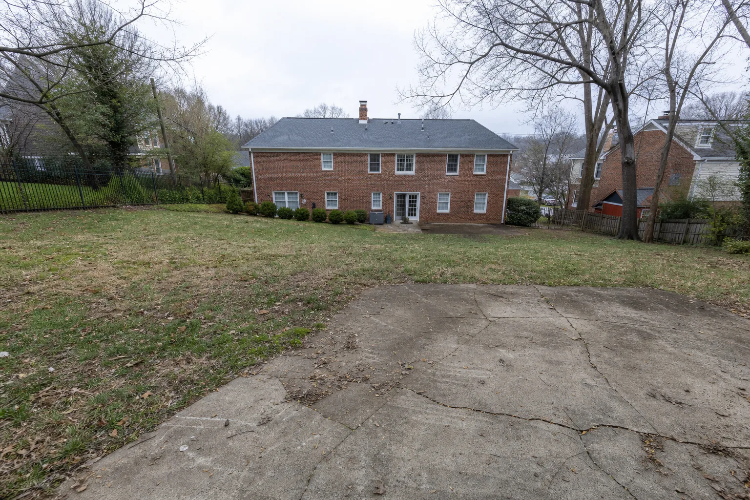 Sloping Chevy Chase backyard before pickleball court construction
