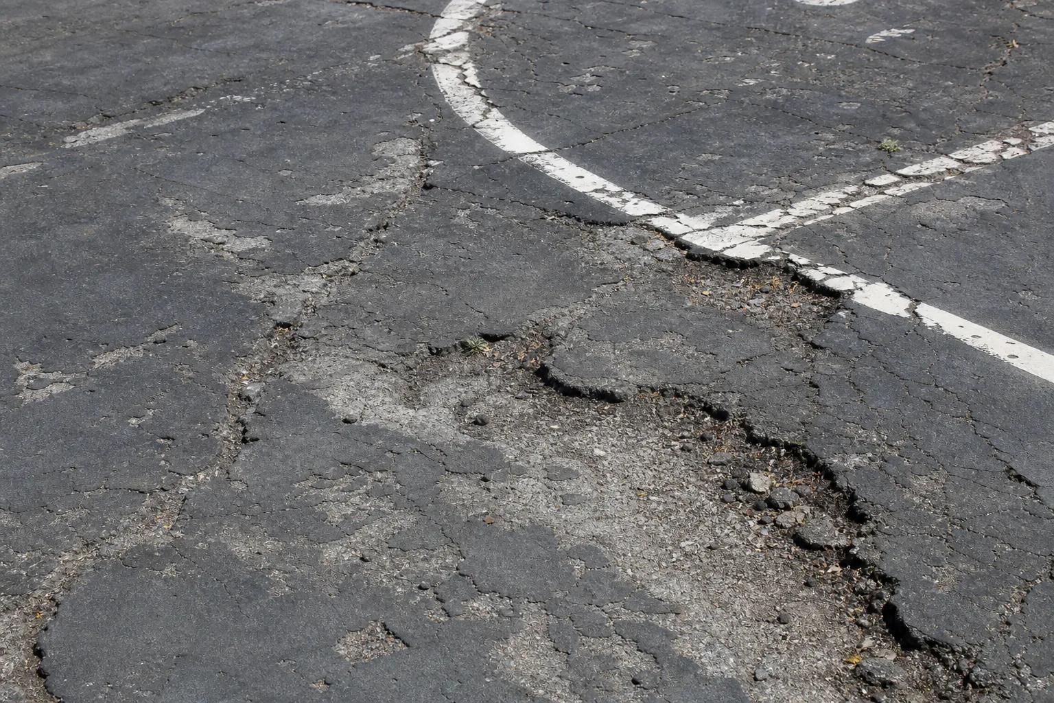 Deteriorated asphalt at the former Devou Park rink