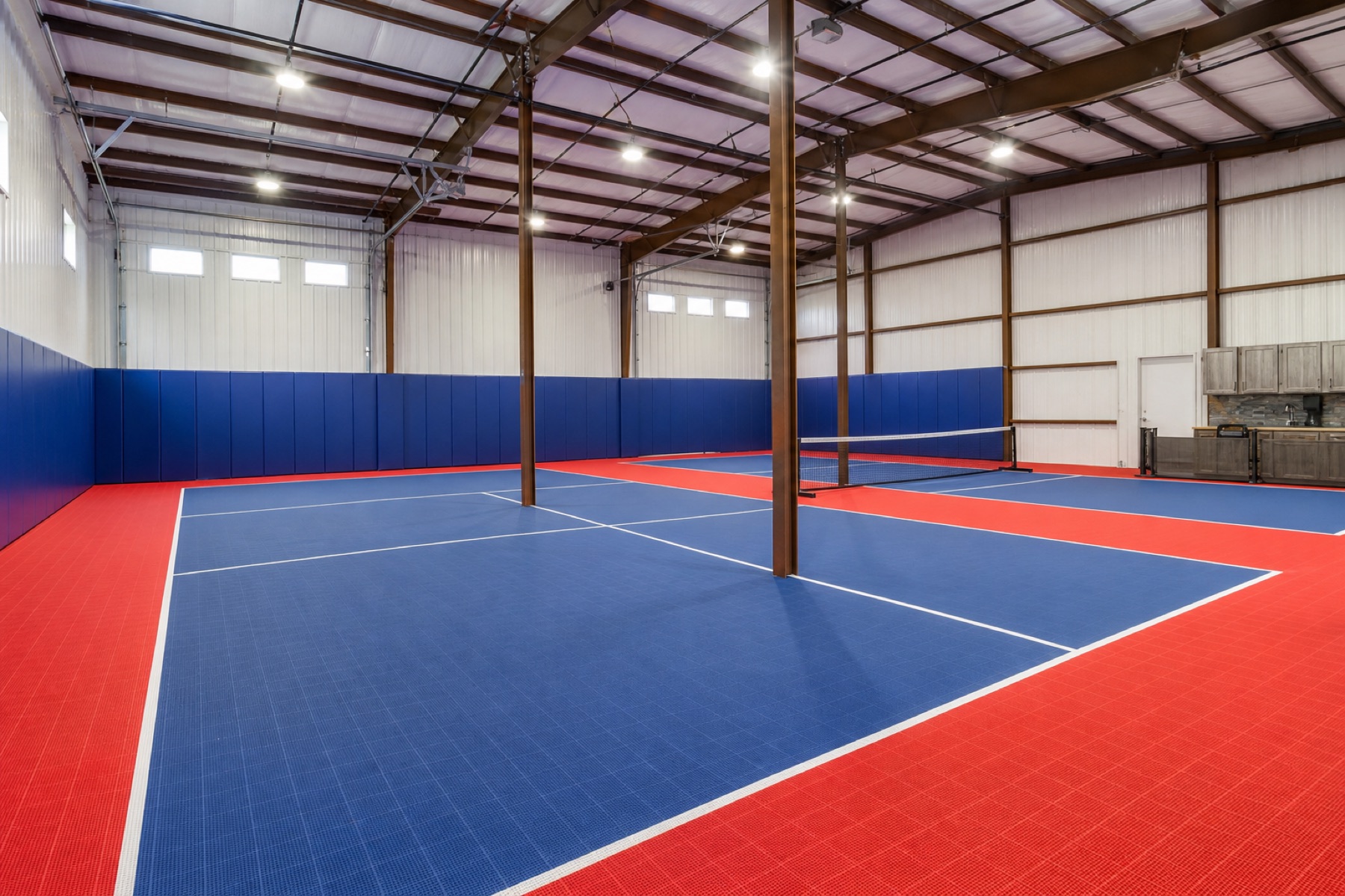 Completed blue and red modular pickleball court inside a converted Georgetown pole barn