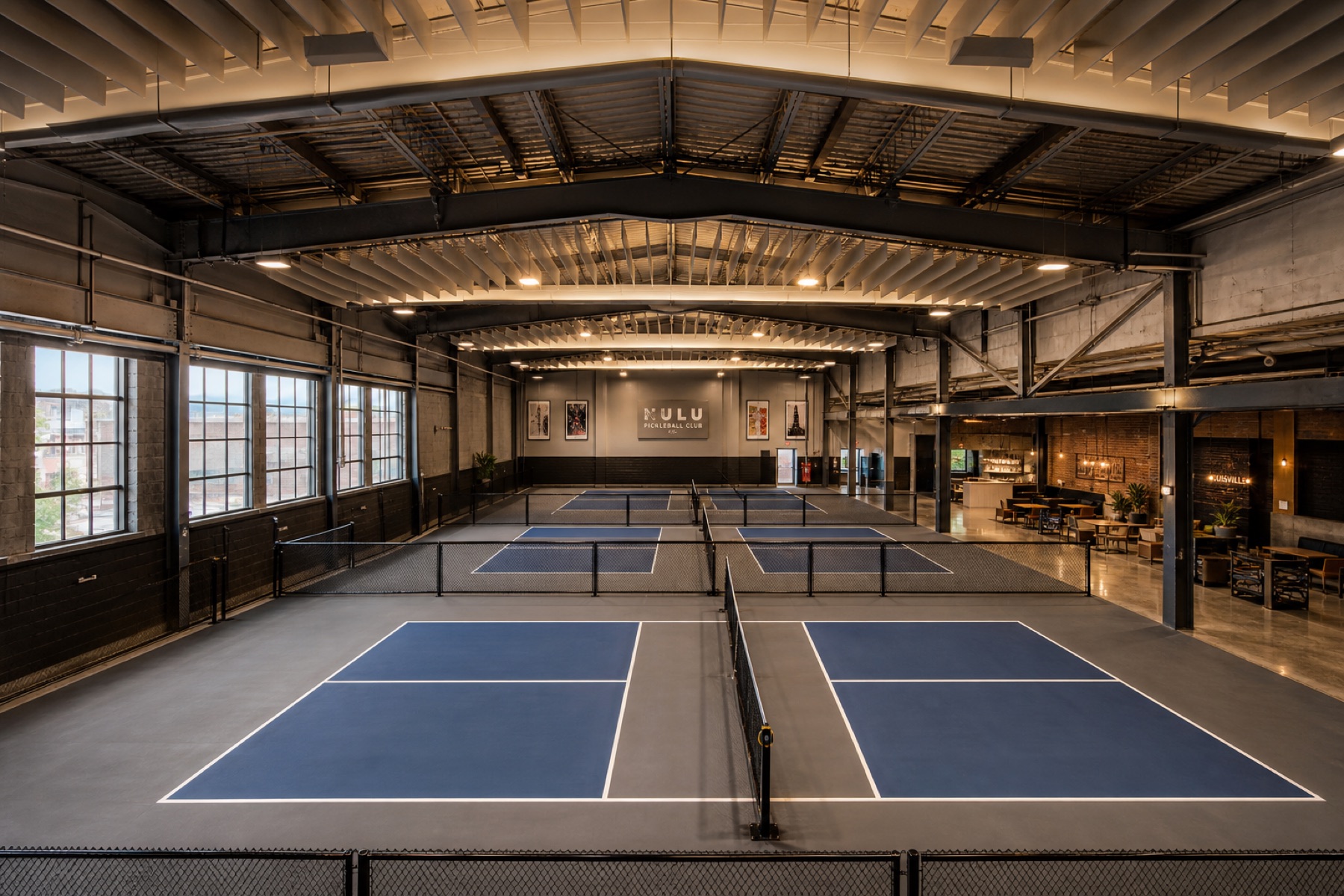 Four completed indoor pickleball courts inside a converted Louisville warehouse